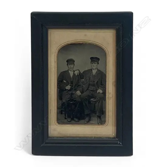 Card-mounted tintype - two seated men in caps,